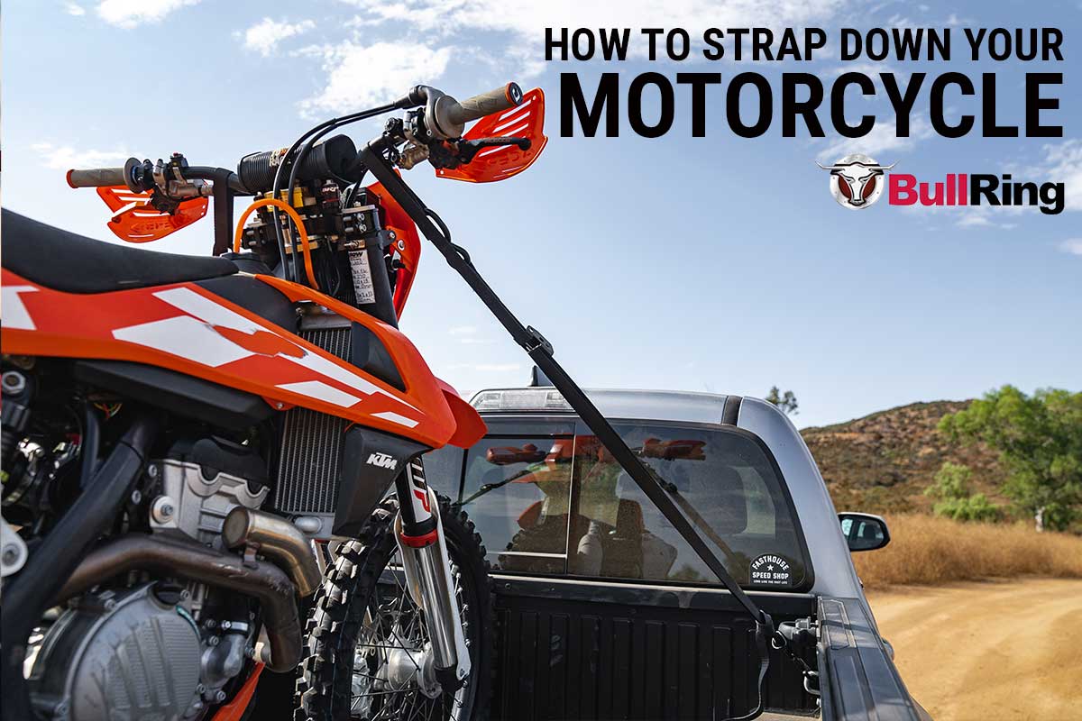 Speedstrap tie-down strap securing motorcycle on truck bed connected to bullring tie-down anchors